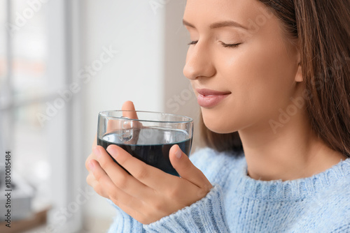 Beautiful young woman drink...