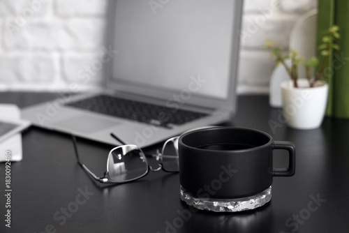 Black coffee cup with coast...