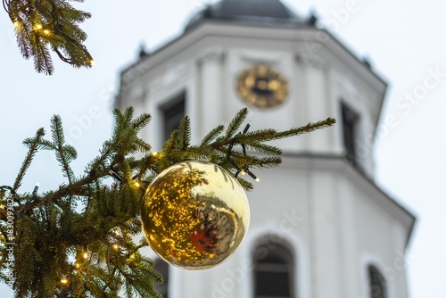 Detail of the Christmas tree with part of the tower bell in a festive city square in Vilnius, Lithuania, Europe