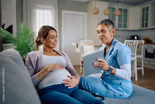 Photography Happy nurse and pregnant woman using digital tablet during home visit