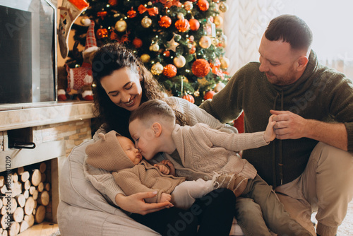 Family celebrating christmas holidays together with newborn baby