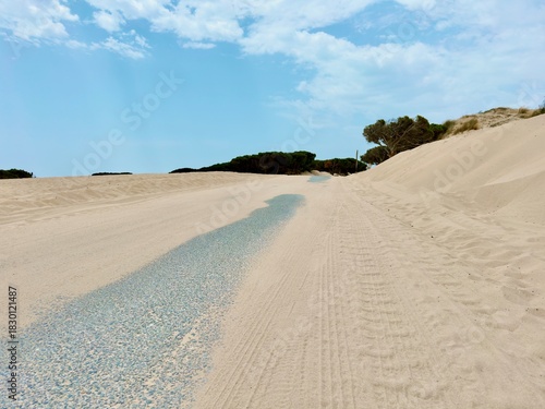 road crossing the large sand dune of Valdevaqueros in front of green mountains of Andalusia, Tarifa, Costa de la Luz, Andalusia, province of Cádiz, Spain, Travel, Tourism