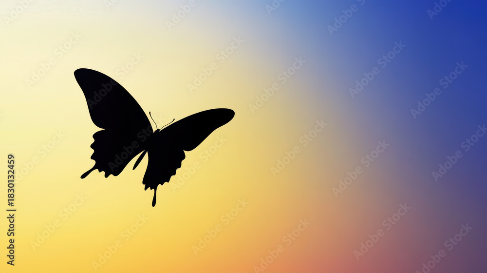 Fototapeta premium Silhouette of butterfly flying against soft gradient sky with warm yellow and cool blue tones creating peaceful mood