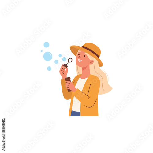Blonde woman blowing soap bubbles wearing yellow hat having joyful time enjoying whimsical day