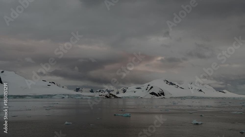 Stunning sunset over icy waters with floating icebergs in Antarctioca