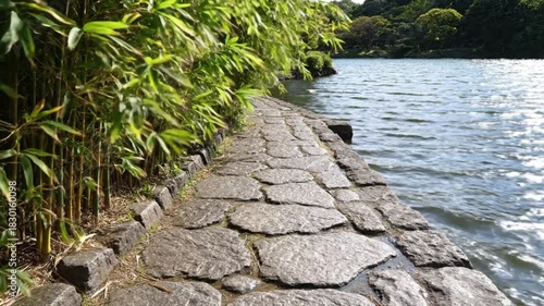 Tranquil Lakeside Path Bamboo Stone and Rippling Water Scene