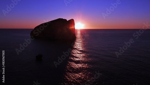 Sunset over the sea at Capo Caccia: limestone promontory located on the northwestern coast of Sardinia island Alghero, Italy