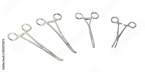 Four stainless steel surgical clamps and hemostats isolated on white background, medical instruments set of metal forceps for hospital surgery, healthcare equipment tools cut out, no people