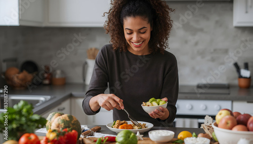 Joyful woman preparing a nourishing and healthy vegetarian meal with fresh vegetables in a bright, modern kitchen at home