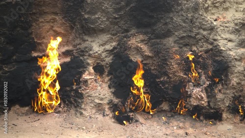 Fire in Yanar Dagh, Azerbaijan - perpetually burning mountain is a natural gas flame that burns indefinitely on a hillside on the Absheron Peninsula and famous tourist attraction.