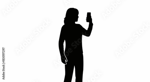 Silhouette of a young woman taking a selfie with her smartphone.