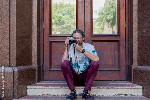 Man seen taking photos with vintage camera