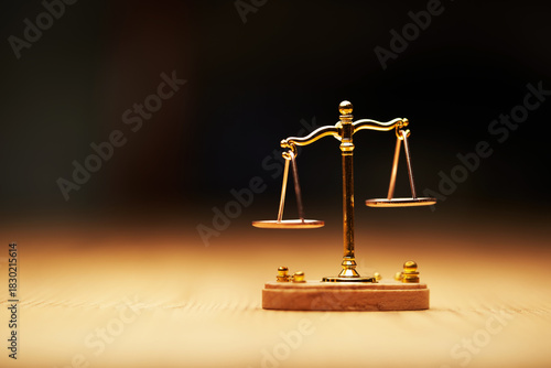 small libra scale on the wooden table.