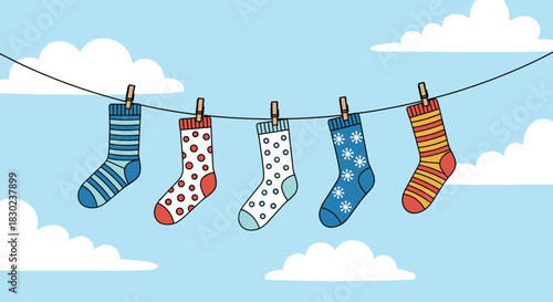 Five colorful socks with various patterns are hanging on a clothesline under a clear blue sky with fluffy white clouds.