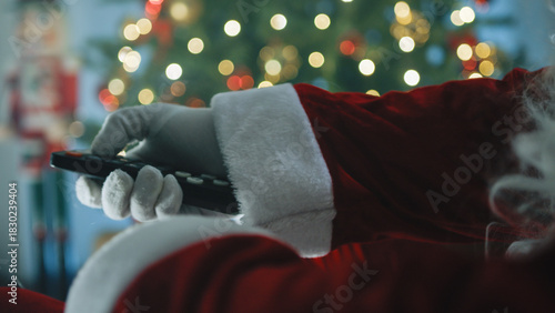 Santa changing channels with remote control