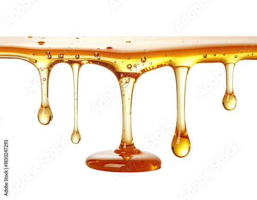 Golden liquid drips, amber, transparent, against black