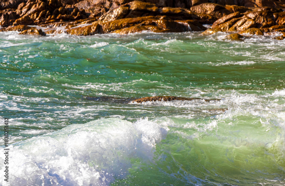Fototapeta premium Tropical turquoise clear water waves rocks Patong Beach Phuket Thailand.
