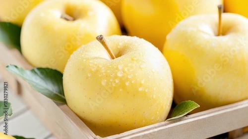 Golden Apples in a Tray: A close-up shot of a wooden tray brimming with luscious, golden apples, their smooth skins glistening, and evoking feelings of fresh produce. 