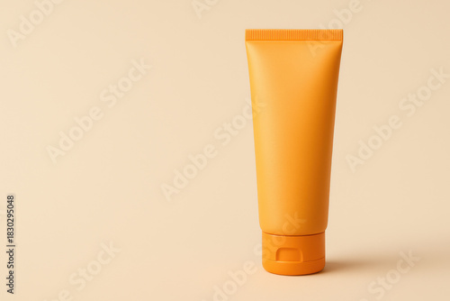 Orange sunscreen tube with realistic texture on minimal beige background, bright and clean skincare product packaging design