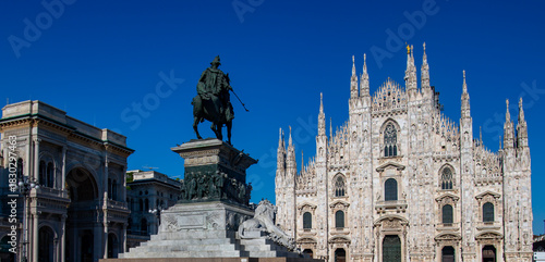 Duomo di Milano cathedral facade with blue sky background. Beautiful Gothic architecture facade of Milan Duomo Cathedral in Italy. Duomo di Milano.