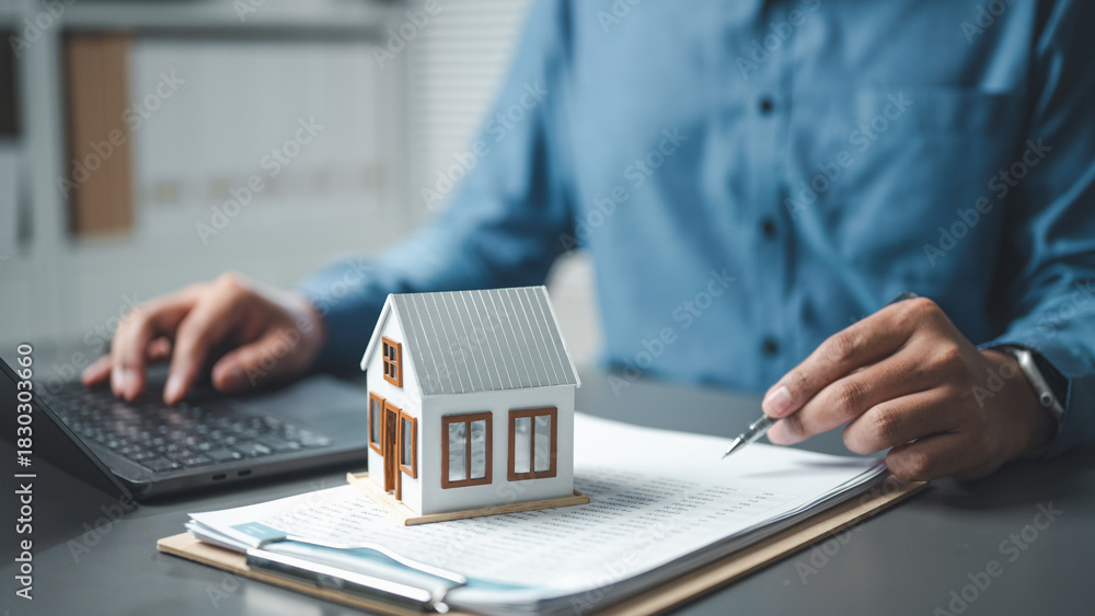 Αυτοκόλλητο realestate, property, mortgage, real estate, loan, contract, A miniature house on documents with a person reviewing paperwork, symbolizing real estate, mortgage, and property investment