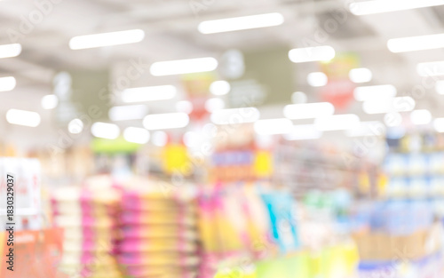 Принти на полотні Blurred supermarket interior with bright lights and soft focus shelves, conveyin