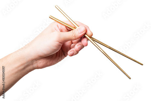 isolated of a man's hand holding a golden chopstick.