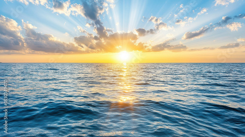 Fototapeta Naklejka Na Ścianę i Meble -  Sunrise ocean horizon sunlight rays over calm sea with golden reflection