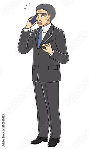 困った表情で電話しているスーツの中年男性