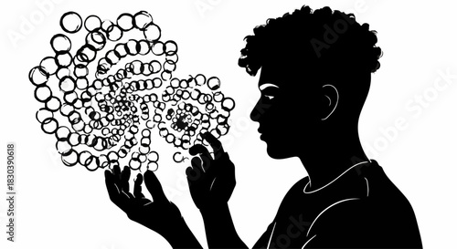 Young man in silhouette contemplating a swirling abstract pattern of circles in his hands.