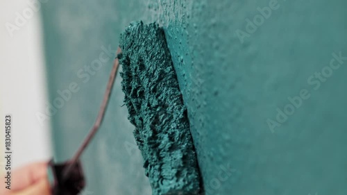 Wall painting process captured in three frames, showcasing a roller applying teal paint, with gradual zoom in on texture and technique