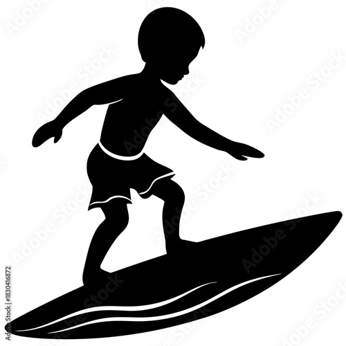 Silhouette of a young boy surfing on a surfboard