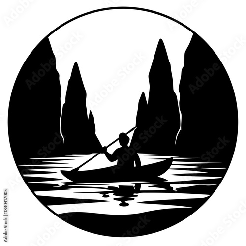 Silhouette of a person kayaking between tall rock formations