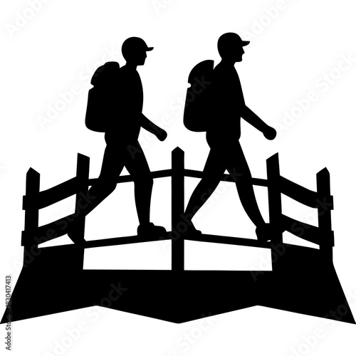 Two hikers with backpacks crossing a wooden bridge