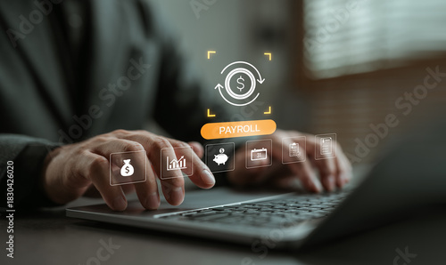 Fototapeta Naklejka Na Ścianę i Meble -  Businessman working on laptop with payroll management system icons. Concept of financial technology, employee salary automation, online payroll software, and digital HR solutions.