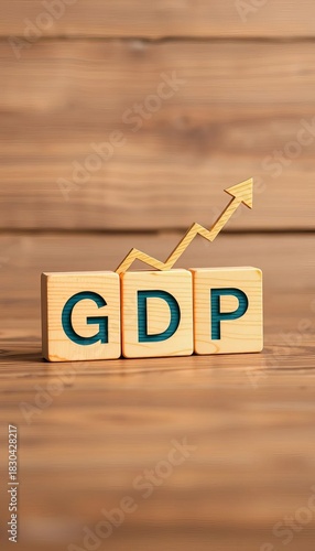 Wooden blocks show GDP and arrows, symbolizing economic volatility,  production,  value