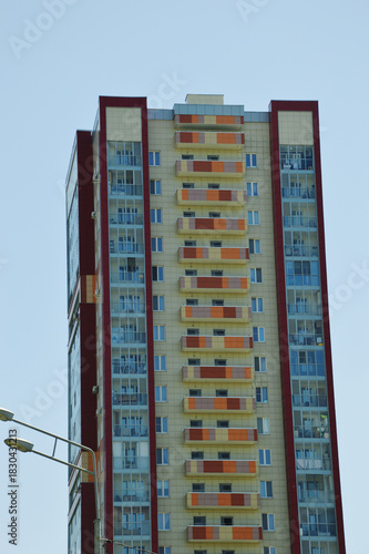 A high-rise residential apartment building with colorful decorative elements. Contemporary urban architecture.