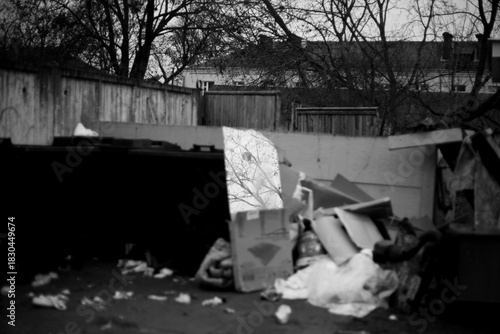 Trash container filled with various waste materials.