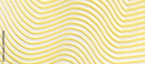 A close-up photo of a creamy texture, light yellow brushstroke, and graceful, smooth lines