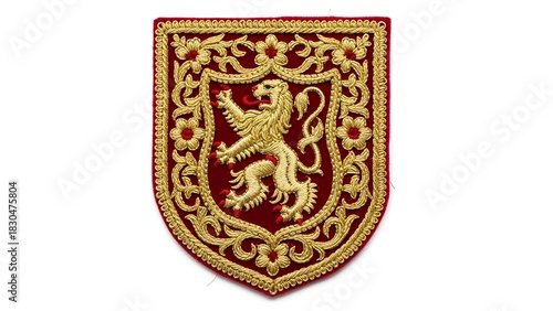 An ornate heraldic shield embroidered with a golden rampant lion on a rich red background, featuring a luxurious floral border