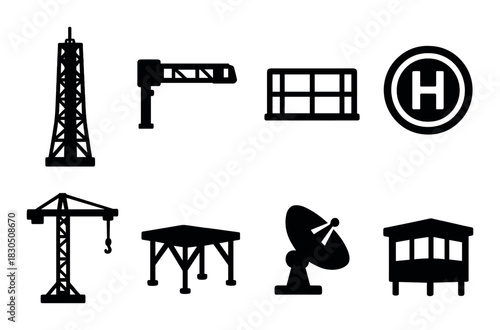 Silhouettes of industrial structures and equipment on black background