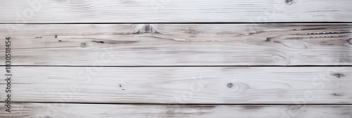 A light-colored wooden surface with a weathered texture, showcasing natural grain patterns and a rustic appearance.