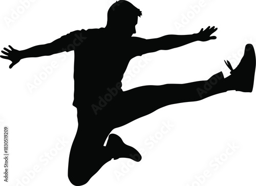 Silhouette of a man performing a high kick jump