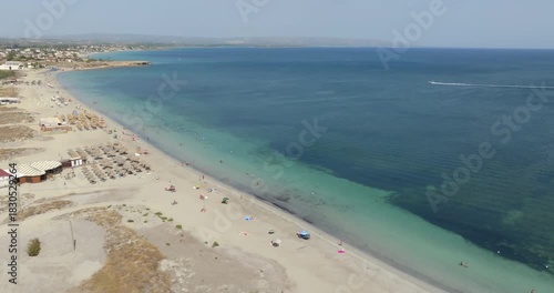 Wallpaper Mural Aerial view of the beach of Marzamemi, a tourist resort in southern Sicily, in the province of Syracuse, Italy. The coast overlooks the Mediterranean Sea, whose waters are turquoise and crystalline. Torontodigital.ca