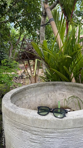 Stylish Black Sunglasses on a Rustic Concrete Pot