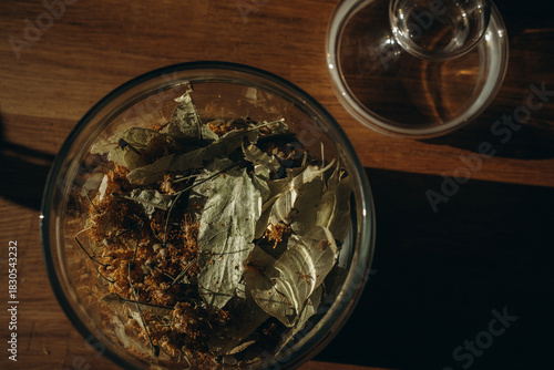 Linden leaves in a closed glass jar close up. Horizontal photo. Glass transparent jar with linden - herbal tea eco collection