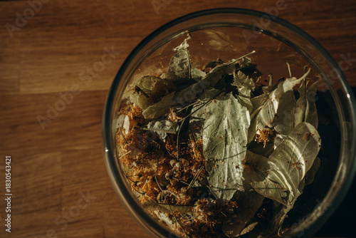 Linden leaves in a closed glass jar close up. Horizontal photo. Glass transparent jar with linden - herbal tea eco collection
