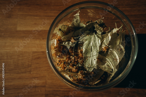Linden leaves in a closed glass jar close up. Horizontal photo. Glass transparent jar with linden - herbal tea eco collection