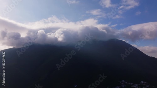 Aerial Pan of Majestic Cerro de la Silla Mountain Shrouded in Storm Clouds