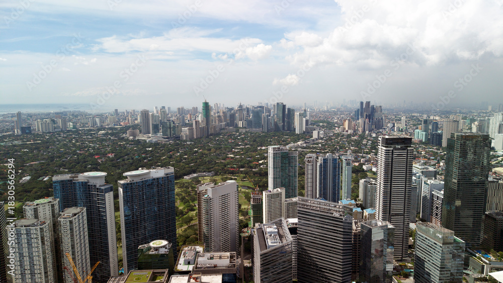 Fototapeta Aerial panorama of Bonifacio Global City business district in Taguig with skyline view of Makati City, Metro Manila, Philippines